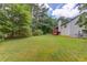 Large grassy backyard with mature trees, offering plenty of space for recreation and relaxation at 1900 Tribble Ridge Dr, Lawrenceville, GA 30045