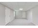 Finished basement area featuring neutral paint, new carpet and two doors at 1900 Tribble Ridge Dr, Lawrenceville, GA 30045