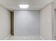 Finished basement with decorative gray brick wall and tile flooring at 1900 Tribble Ridge Dr, Lawrenceville, GA 30045