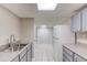 Basement kitchen featuring modern cabinets, sink, and views of the brick accent wall at 1900 Tribble Ridge Dr, Lawrenceville, GA 30045