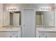 Bright bathroom featuring dual sinks, granite countertops, and modern lighting fixtures at 1900 Tribble Ridge Dr, Lawrenceville, GA 30045