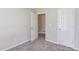 Bedroom with open door way to another room with plush carpet and neutral colored walls at 1900 Tribble Ridge Dr, Lawrenceville, GA 30045