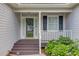 Inviting covered porch with decorative railing and colorful flowers at 1900 Tribble Ridge Dr, Lawrenceville, GA 30045