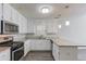 Stylish kitchen boasting white cabinets, granite countertops, and stainless steel appliances at 1900 Tribble Ridge Dr, Lawrenceville, GA 30045