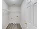 Compact laundry area features wood-look vinyl flooring, wire shelving, and modern hookups at 1900 Tribble Ridge Dr, Lawrenceville, GA 30045
