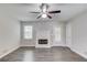 Bright living room with a ceiling fan, a fireplace, wood-look floors, and a glass door at 1900 Tribble Ridge Dr, Lawrenceville, GA 30045