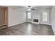 Spacious living room with a fireplace, a ceiling fan, wood-look floors, and a glass door at 1900 Tribble Ridge Dr, Lawrenceville, GA 30045