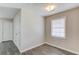 Neutral room with wood-look floors, a window with blinds, and two white doors at 1900 Tribble Ridge Dr, Lawrenceville, GA 30045