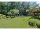 A well-manicured green backyard with trees and gardens at 3675 Ridgeway Ter, Suwanee, GA 30024