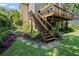 Two-story deck overlooking a luscious green backyard and landscaping at 3675 Ridgeway Ter, Suwanee, GA 30024