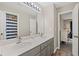 Bathroom features a double sink vanity with gray cabinets, a large mirror, and a separate shower area at 3675 Ridgeway Ter, Suwanee, GA 30024
