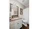 Elegant bathroom featuring a granite vanity top, framed mirror, and white cabinet with stylish detailing at 3675 Ridgeway Ter, Suwanee, GA 30024