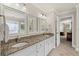 Bright bathroom featuring double sinks, granite countertops, and access to the bedroom at 3675 Ridgeway Ter, Suwanee, GA 30024