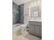 Contemporary bathroom features a tub, shower with modern gray tile and a bright gray vanity at 3675 Ridgeway Ter, Suwanee, GA 30024