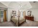 Spacious main bedroom boasts a tray ceiling, fan, and generous natural light from surrounding windows at 3675 Ridgeway Ter, Suwanee, GA 30024
