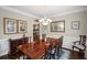 Bright dining room features hardwood floors, wainscoting, a chandelier, and an elegant area rug at 3675 Ridgeway Ter, Suwanee, GA 30024