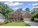 Charming brick home with a manicured lawn, colorful flowerbeds, and an attached two-car garage at 3675 Ridgeway Ter, Suwanee, GA 30024