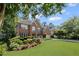 Beautiful brick home with a lush green lawn and professionally landscaped garden at 3675 Ridgeway Ter, Suwanee, GA 30024