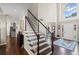 Grand foyer with a staircase, hardwood floors, large window, and a view of the front door at 3675 Ridgeway Ter, Suwanee, GA 30024