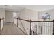 Bright hallway with white railings overlooks the foyer and features a large arched window at 3675 Ridgeway Ter, Suwanee, GA 30024