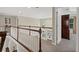 Hallway overlooks foyer, highlighting the home's open layout and natural light from large window at 3675 Ridgeway Ter, Suwanee, GA 30024