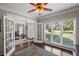 Bright office with hardwood floors, French doors, and large windows with a view of the front yard at 3675 Ridgeway Ter, Suwanee, GA 30024