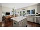 Open kitchen with breakfast island, stainless appliances and backyard views at 3675 Ridgeway Ter, Suwanee, GA 30024
