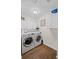 Clean laundry room with modern appliances, ample cabinet space, and wood-look flooring at 3675 Ridgeway Ter, Suwanee, GA 30024