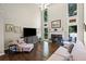 Bright living room boasts high ceilings, large windows, fireplace, and hardwood floors at 3675 Ridgeway Ter, Suwanee, GA 30024
