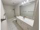 Bathroom featuring a white vanity, tile floors, and shower-tub combination at 46 Timber Walk Dr, Sharpsburg, GA 30277