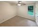 Carpeted bedroom with ceiling fan and window letting in natural light at 46 Timber Walk Dr, Sharpsburg, GA 30277