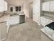 Bright kitchen with white cabinets, stainless steel appliances and stone countertops at 46 Timber Walk Dr, Sharpsburg, GA 30277