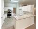 Clean kitchen with white cabinets, stainless steel appliances, and light countertops at 46 Timber Walk Dr, Sharpsburg, GA 30277
