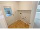 Functional laundry room with exterior access and shelving at 46 Timber Walk Dr, Sharpsburg, GA 30277