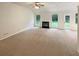 Bright living room featuring a fireplace, large windows, and access to outdoor living at 46 Timber Walk Dr, Sharpsburg, GA 30277