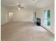 Open living room with a fireplace, large windows, and neutral decor at 46 Timber Walk Dr, Sharpsburg, GA 30277