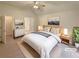 Staged bedroom featuring neutral decor, ample natural light, and ensuite bathroom access at 46 Timber Walk Dr, Sharpsburg, GA 30277