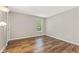 Comfortable bedroom featuring sleek hardwood floors and bathed in natural light at 1362 Brockett Pl, Clarkston, GA 30021