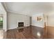 Spacious living room with hardwood floors, a cozy fireplace, and a calming neutral color palette at 1362 Brockett Pl, Clarkston, GA 30021
