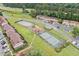 Aerial view of community tennis courts and playground surrounded by mature trees and manicured lawns at 1810 Ashborough Se Rd # G, Marietta, GA 30067