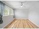 Bright bedroom featuring stylish wood floors, modern ceiling fan, and window with decorative curtains at 1810 Ashborough Se Rd # G, Marietta, GA 30067