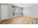 Bright bedroom featuring stylish wood floors, modern ceiling fan, and window with decorative curtains at 1810 Ashborough Se Rd # G, Marietta, GA 30067