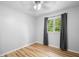 Bedroom featuring stylish wood floors, ceiling fan, and a window with curtains at 1810 Ashborough Se Rd # G, Marietta, GA 30067
