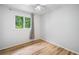 Bedroom featuring stylish wood floors, a ceiling fan, and a window with curtains at 1810 Ashborough Se Rd # G, Marietta, GA 30067