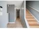 Hallway with neutral walls leads to wood stairs, offering a bright and open feel at 1810 Ashborough Se Rd # G, Marietta, GA 30067