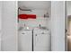 Laundry closet with a white stacked washer and dryer unit behind folding doors at 1810 Ashborough Se Rd # G, Marietta, GA 30067