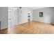 Open living room featuring hardwood floors, neutral paint, and a view into the hallway at 1810 Ashborough Se Rd # G, Marietta, GA 30067