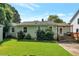 Well-maintained backyard with lush green grass, mature landscaping, and a cozy porch area at 2002 Shalimar Ne Dr, Chamblee, GA 30345
