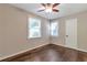 Neutral bedroom with hardwood floors, fan, two windows, and closet at 2002 Shalimar Ne Dr, Chamblee, GA 30345