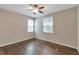 Neutral bedroom with hardwood floors, two windows, and ceiling fan at 2002 Shalimar Ne Dr, Chamblee, GA 30345